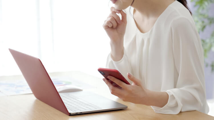 ノートパソコンで業者を検索する女性